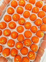Orange motichoor ladoo garnished with nuts - Desi Ghee Motichur Ladoo